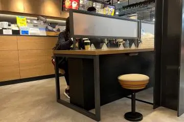Tullys Coffee also serves sandwiches and had phone / laptop chargers at the far end of the cafe