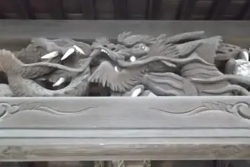 Some buildings have striking dragons carved under the eaves