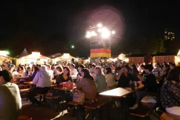 German flags flew proudly while people drank beer and gluhwein and ate traditional food by moonlight.