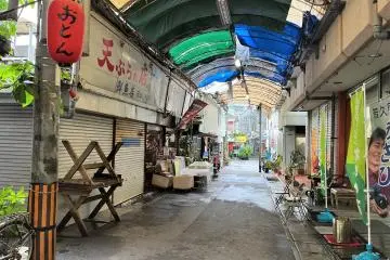 Tarps in primary colours and aged shutters make a walk through these alleyways positively retro.