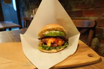 Avocado and homemade bacon on a Bomburger
