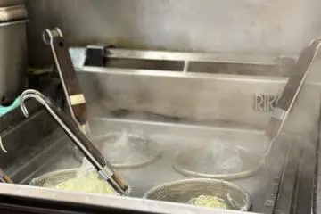 The ramen is cooked in front of the patrons