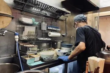 The chef cooking the ramen