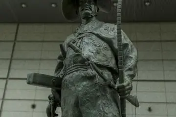 A large statue of a Samurai lending a regal prescence to a modern cathedral of minds
