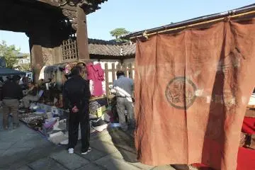 A vendor selling beautiful brown noren curtains