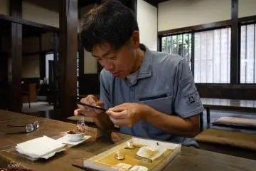A craftsman shows the “Chin-kin” technique on the surface of lacquered wajima-nuri chopsticks.