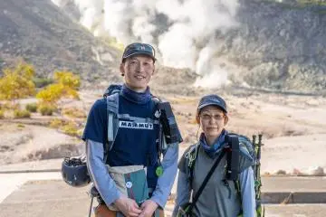 Hagi (left) and Yukiko (right) standing at the base of Mt. Io