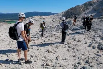 Mt. Io guide Yukiko (blue helmet) explains about the mountain’s features to the group