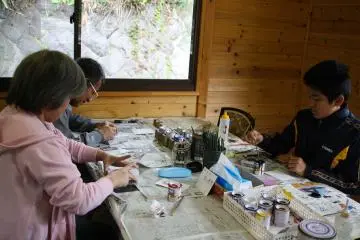 A small family concentrating on their Kusatsu limestone masterpieces