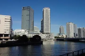 The view through the big clear window is of water and skyscrapers.