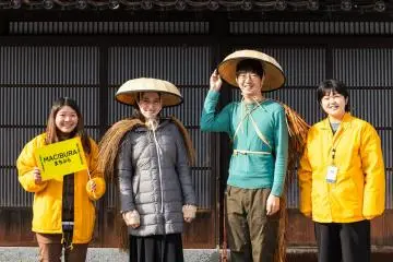 Wearing mino, traditional Japanese rainwear