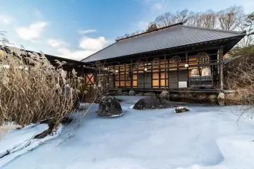 Traditional structure beside frozen pond