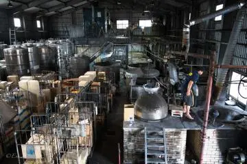 One of Mr. Sakimoto’s sons works at the factory checking one of the important processes to make Awamori sake.