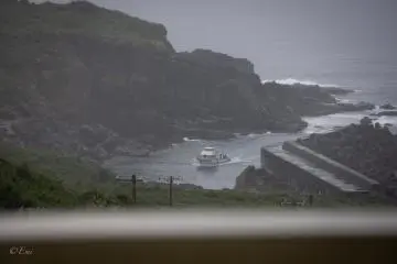 A boat enters a Yonaguni port.