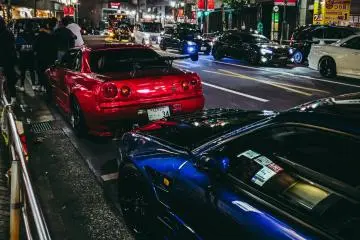 Neon-lit Japanese cars on the streets of Tokyo at night (Photo: Felix Fuchs / Unsplash)