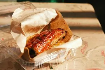A takeout portion of unagi on a bed of rice