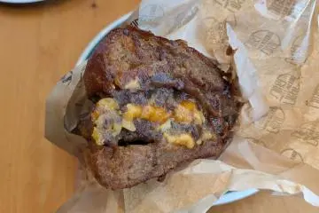 Here we go! Caramelised onions, cheese and burger come together on the seared side