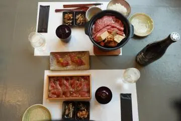 Omi beef sushi, Sukiyaki Nabe, and Shiga sake with assorted side dishes (Photo: Cathy Guex)
