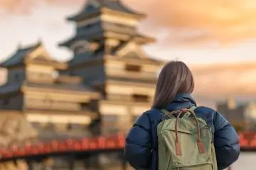 A solo traveler looking at Matsumoto Castle