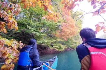 Canoeing on a waveless waterway of Lake Shikotsu in autumn