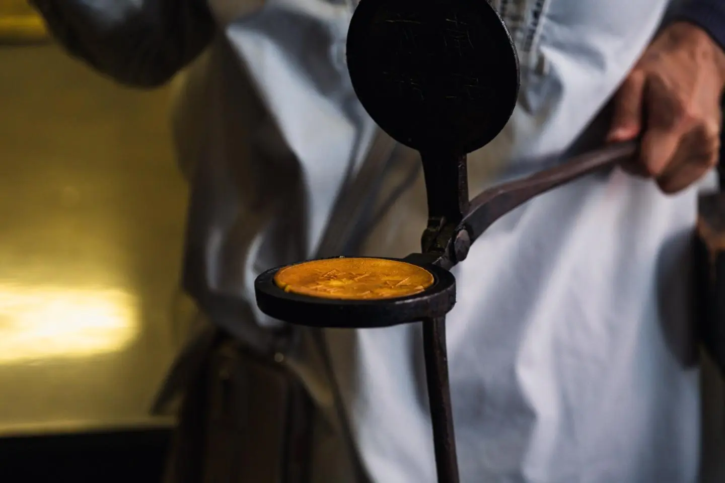 Handmade senbei in an iron mold (Photo: Todd Fong)