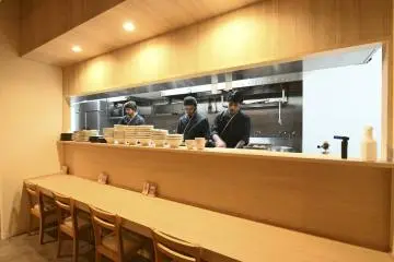 Counter seats facing a live kitchen