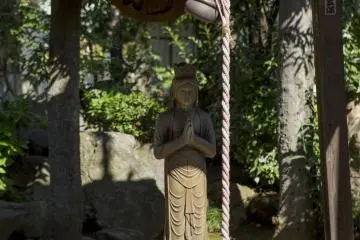 <p>This statue of Amida caught my eye, as it appeared to seek shelter from the sun</p>