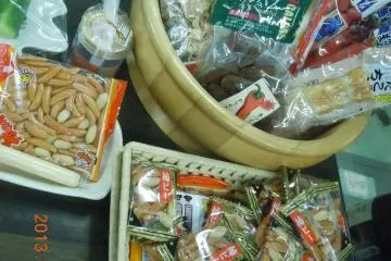 One ticket for a larger snack, or five small packs of peanuts, but it seems you can also get a small pack of peanuts with every two or three glasses of sake