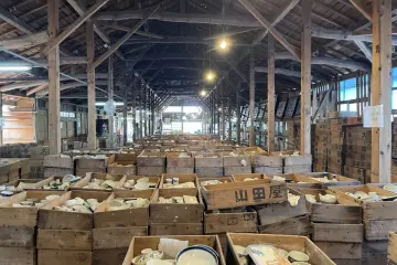 Wooden crates of tea ceramics in a rustic warehouse