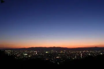 Last rays of light slip behind the city