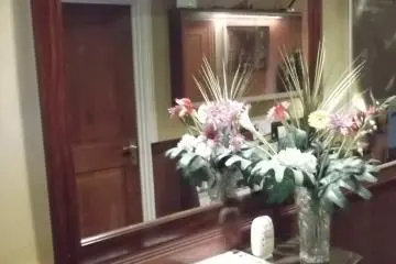 <p>A cabinet and mirror in the corridor</p>