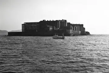 A fishing boat in front of Gunkanjima