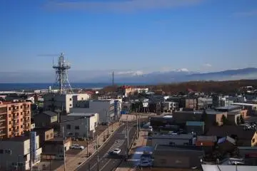 From the hotel room, looks out over the town with a distant sea view.