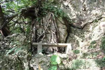 There are about a half dozen stone benches along the path to the top, some in precarious locations like this one