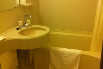 Bathroom with washlet and combined shower bath