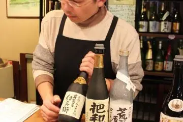 <p>At the tasting counter, request the sake tasting course then decide which three sake to sample. Sake is poured from subtle to strong taste, often indicated by the drink's color</p>