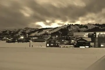 <p>View of Urasa&nbsp;Station from a distance from the East exit.&nbsp;In the background you can see some of the hills with its&nbsp;ski slopes.</p>