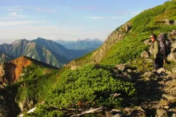 Clouds, mountains and green grass in Nagano Prefecture Japan, between Mt Shirouma and Mt Karamatsu.