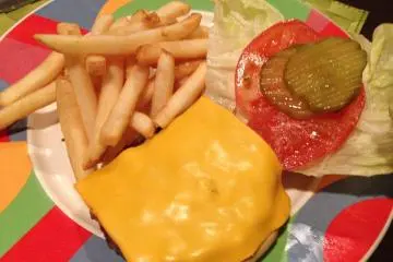 <p>The Okuma Burger is a six ounce all beef patty with melted cheese, French fries and condiments</p>