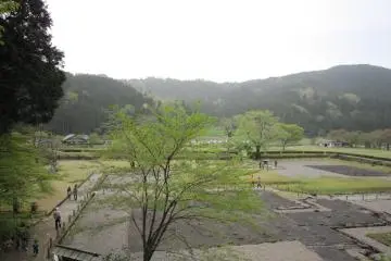 Ruins of the Asakura family residence viewed from one of the gardens above. Idyllic fields and mountains are in the background
