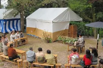 Guests are watching the master's masterly tea technique with wonder and admiration
