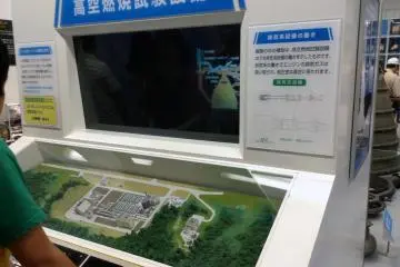 A video monitor along with nearby cases exhibit information on engine design and development.&nbsp;