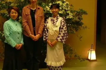 <p>This photo was taken during my first visit to the restaurant. I am in the center;&nbsp;that's my student on my left, and our server on my right. I include it so that you can see the server's kimono</p>