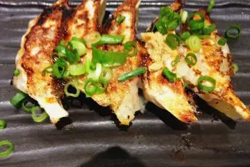 <p>Stunning mini gyoza dumplings are best eaten with the ginger seasoning and la yu chili dipping sauce</p>