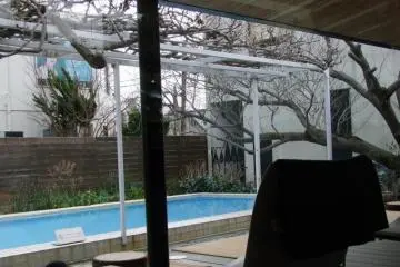 There is a pool outside the large window.