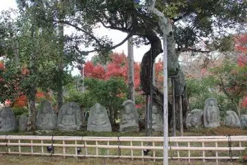 <p>The stone Buddhist statues rest near the pond</p>