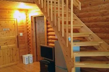 <p>Inside the log cabin. In this cabin, two beds are downstairs, and four upstairs. There is also a living room area, bathroom and separate shower.</p>