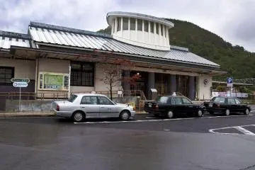 A line of taxis waiting for customers at Arita train station
