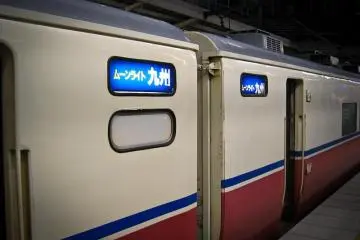 Moonlight Kyushu Carriages with signs in Japanese